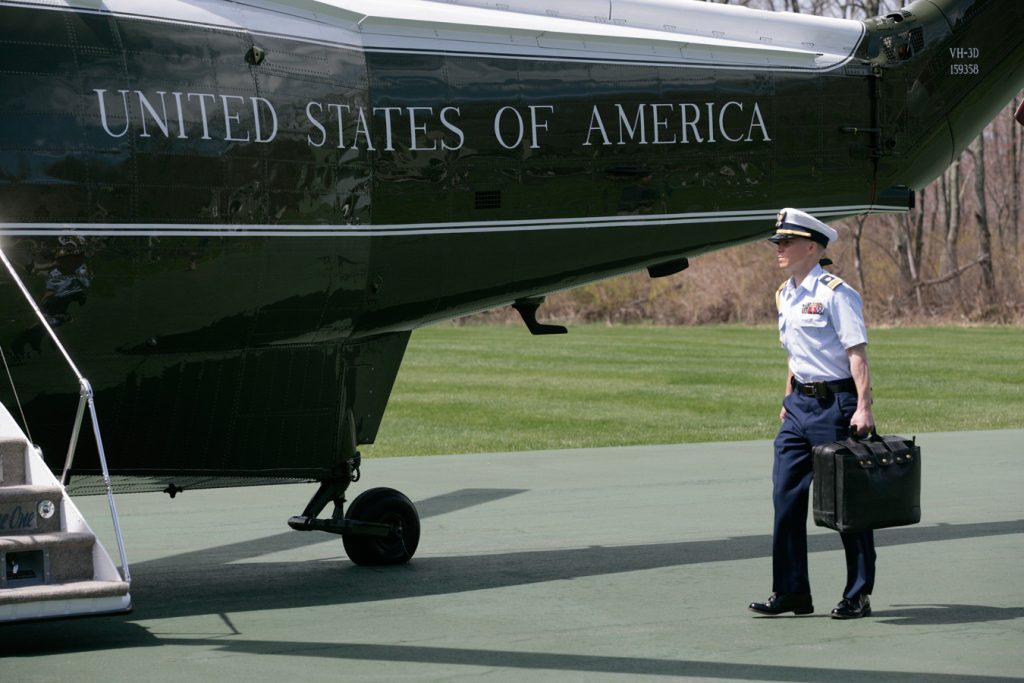 An aide carries the nuclear 'satchel'