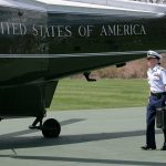 An aide carries the nuclear 'satchel'