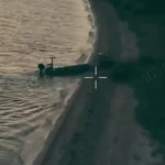 A videograb from footage released by Ukraine’s 123rd Separate Territorial Defence Brigade showing a UGV being deposited by an unmanned landing craft onto the Russian-occupied Kinburn Spit. (123rd Separate Territorial Defence Brigade)
