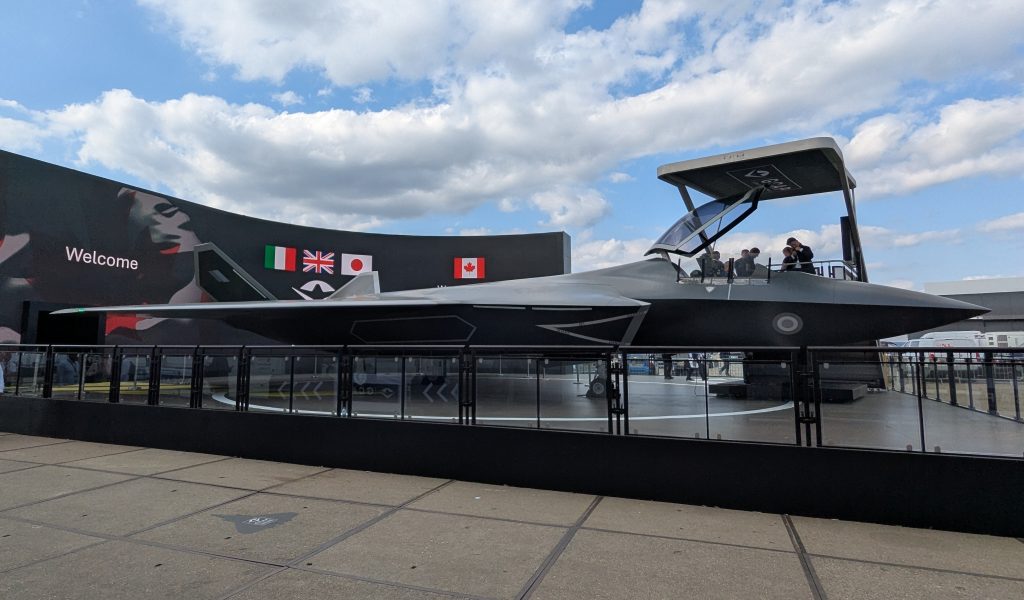 The full-size GCAP mock-up outside the Edgewing building at the 2026 Farnborough International Airshow, with the Canadian flag joining those of the UK, Italy and Japan on the electronic billboard behind it with Canada becoming an Observer Nation on the programme. (P Felstead)