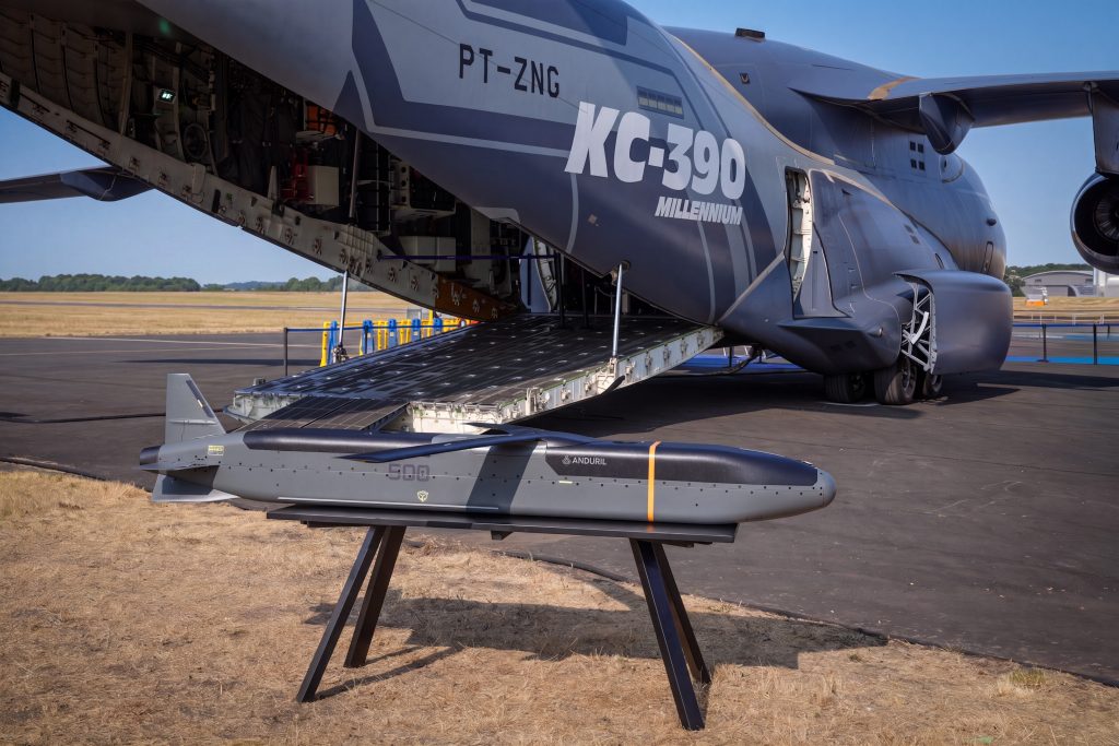 An Anduril Barracuda-500M stand-off cruise missile pictured beside a KC-390 Millennium tanker-transport aircraft at FIA 2026, where an MoU was signed on integrating a pallet-launched Barracuda-500M onto the Millennium. (Embraer)